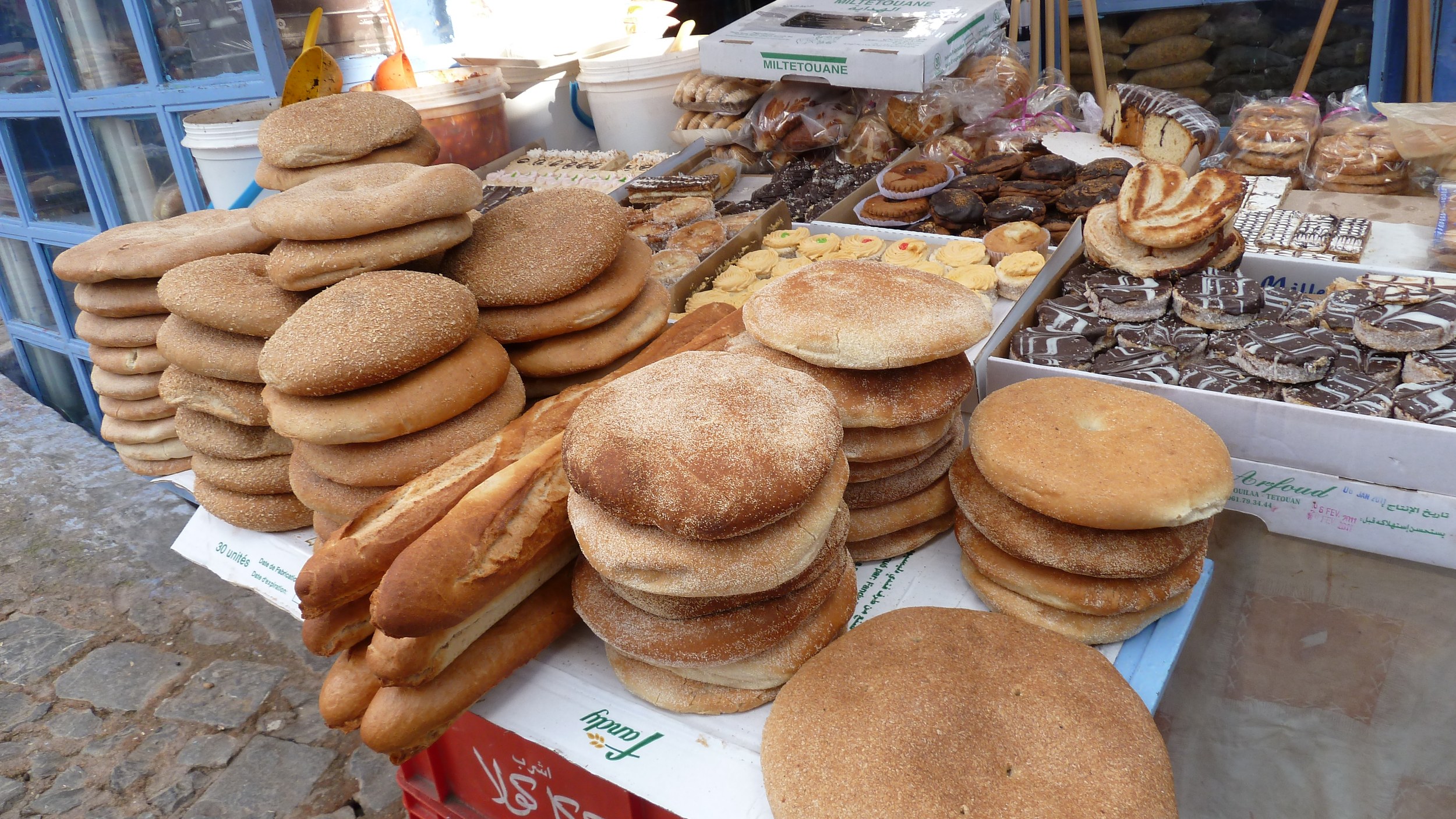 Étal de pains traditionnels ronds et de baguettes sur un marché de Chefchaouen